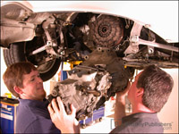 Bentley Service Publications Team removing Porsche Boxster transmission.