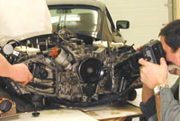 Bentley Service Publications Team photographing a Porsche 911 engine.
