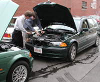 Bentley Service Publications Team comparing BMW engine components.