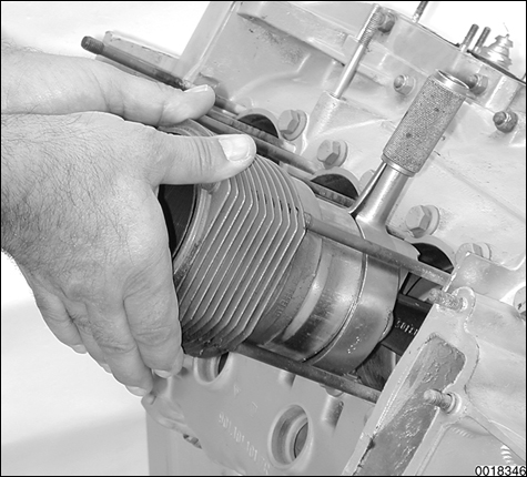 Detailed illustrations for each repair procedure, including use of special tools. Cylinder installation procedure shown using piston ring compressor.
Engine Disassembly and Assembly
page 102-28